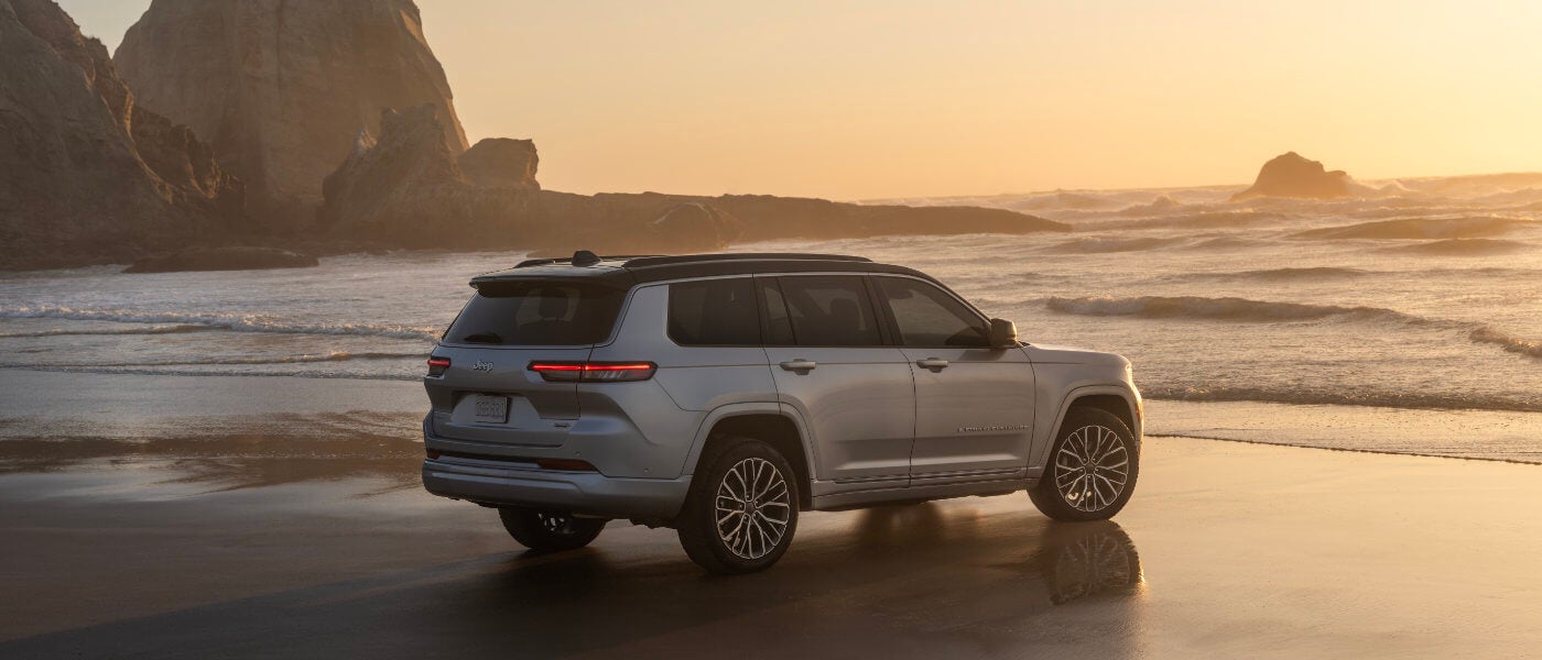 2026 Jeep Grand Cherokee facing ocean rocks