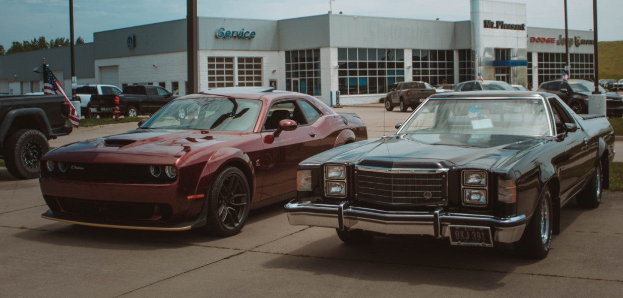 Modern and classic cars displayed outside Coleman Auto